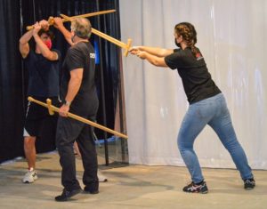 Tony coaches students in sword fighting techniques